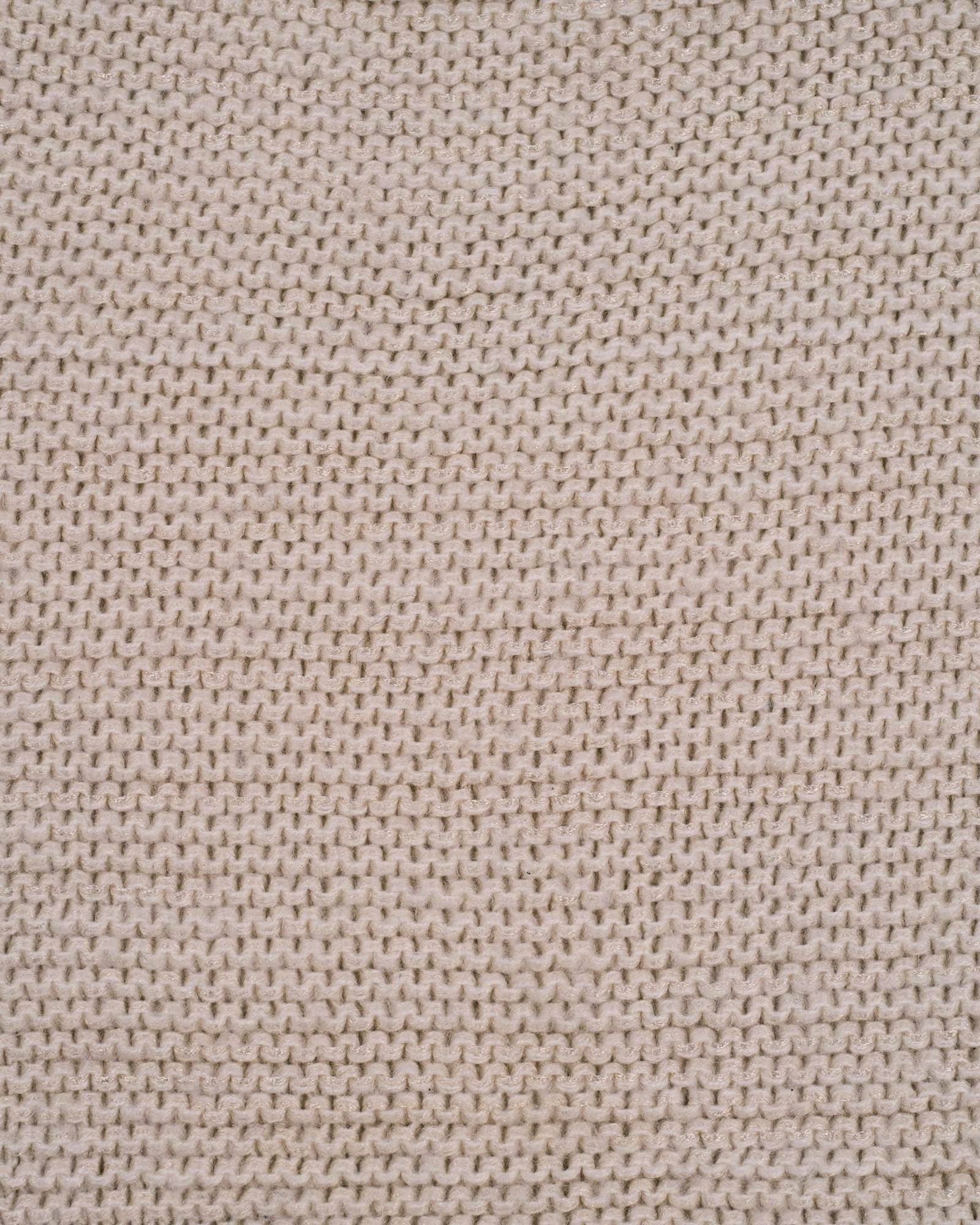 A close-up of a fine, softly textured cream knit fabric.